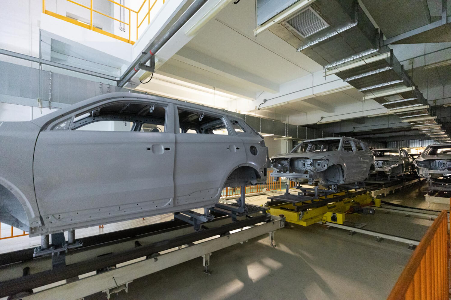 several cars in the production hall at the factory