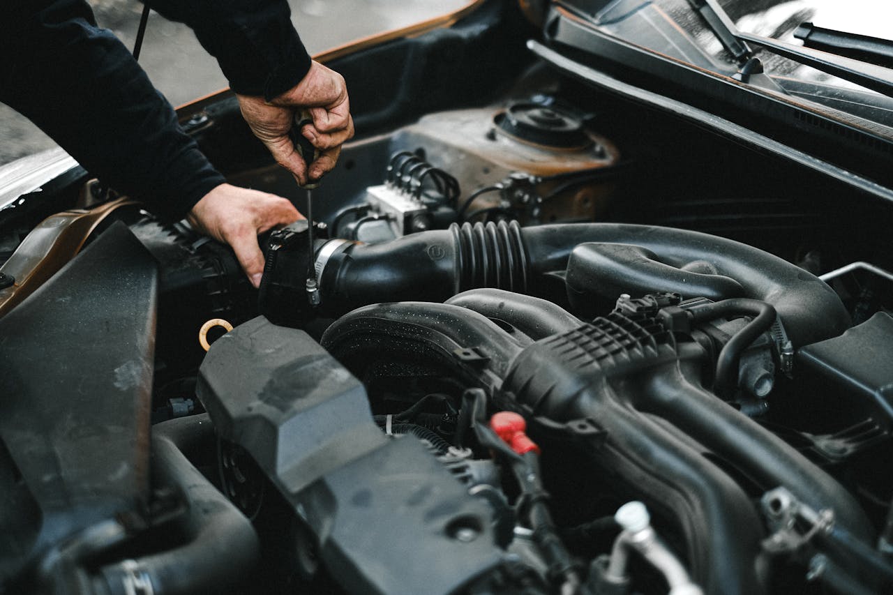 a car mechanic is fixing an engine