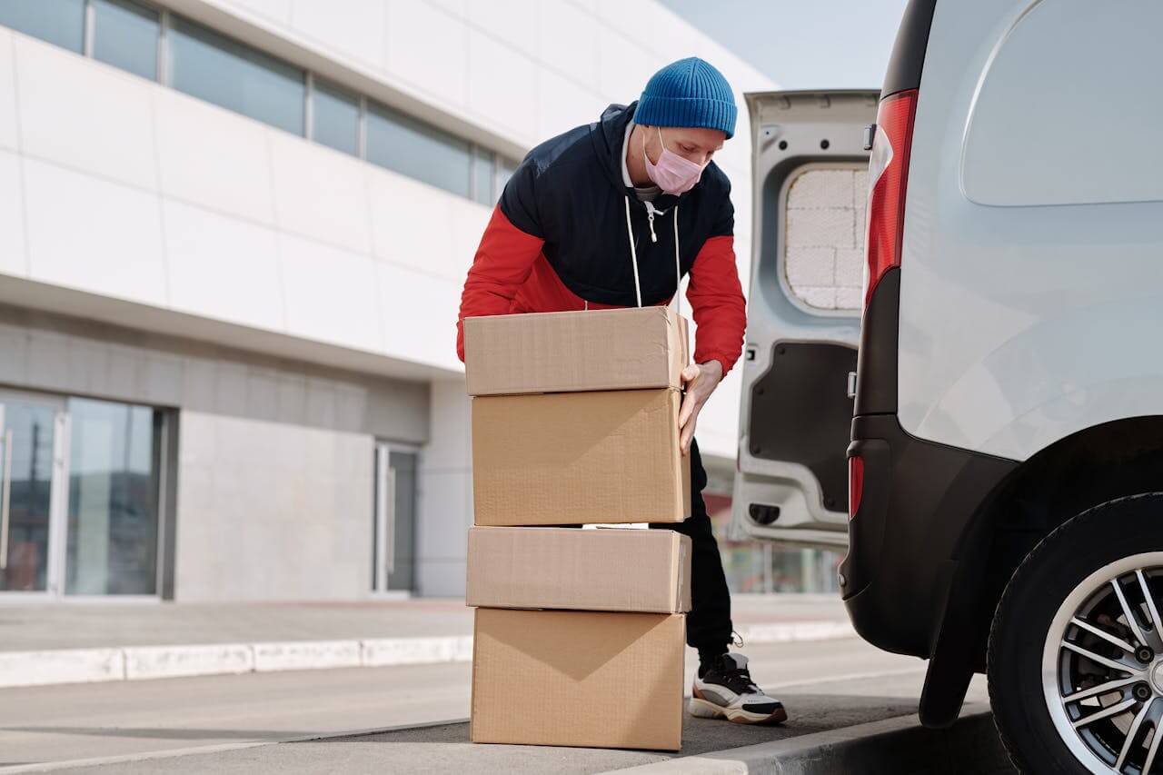 the driver loads the boxes into the delivery vehicle