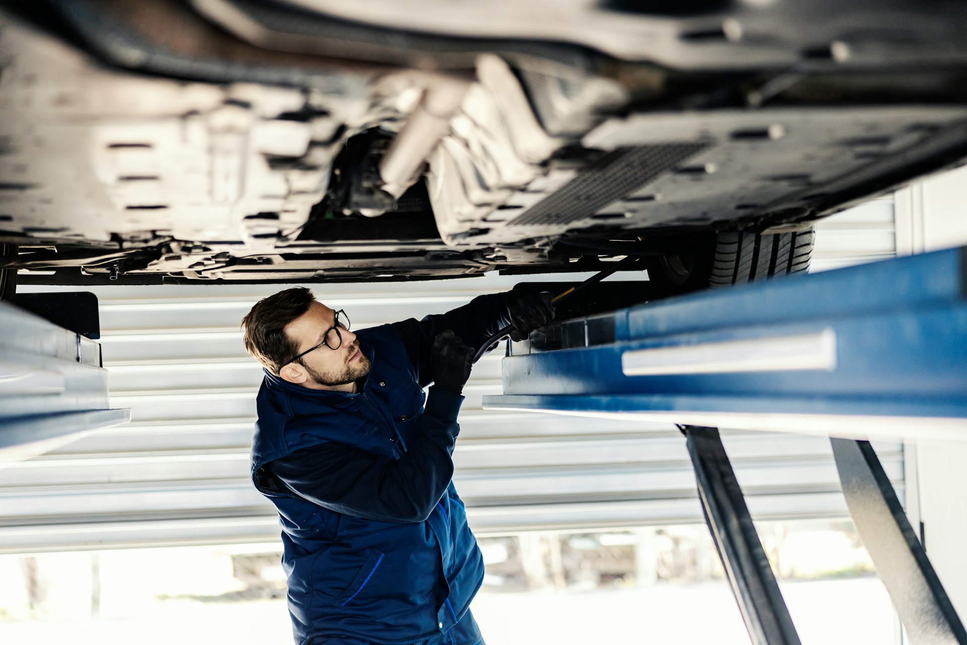 a mechanic checking a salvage car
