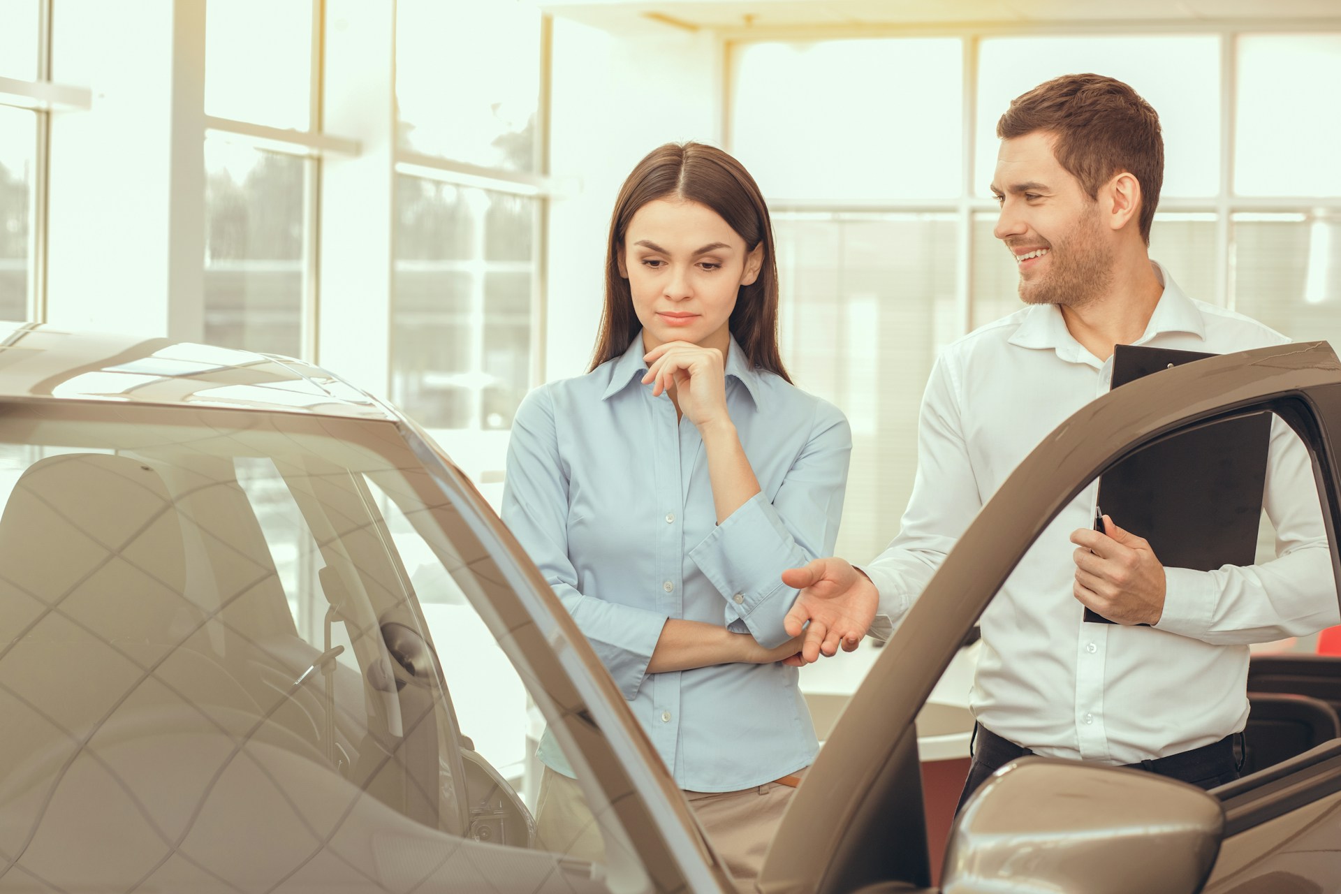 buyer and seller inspecting a car