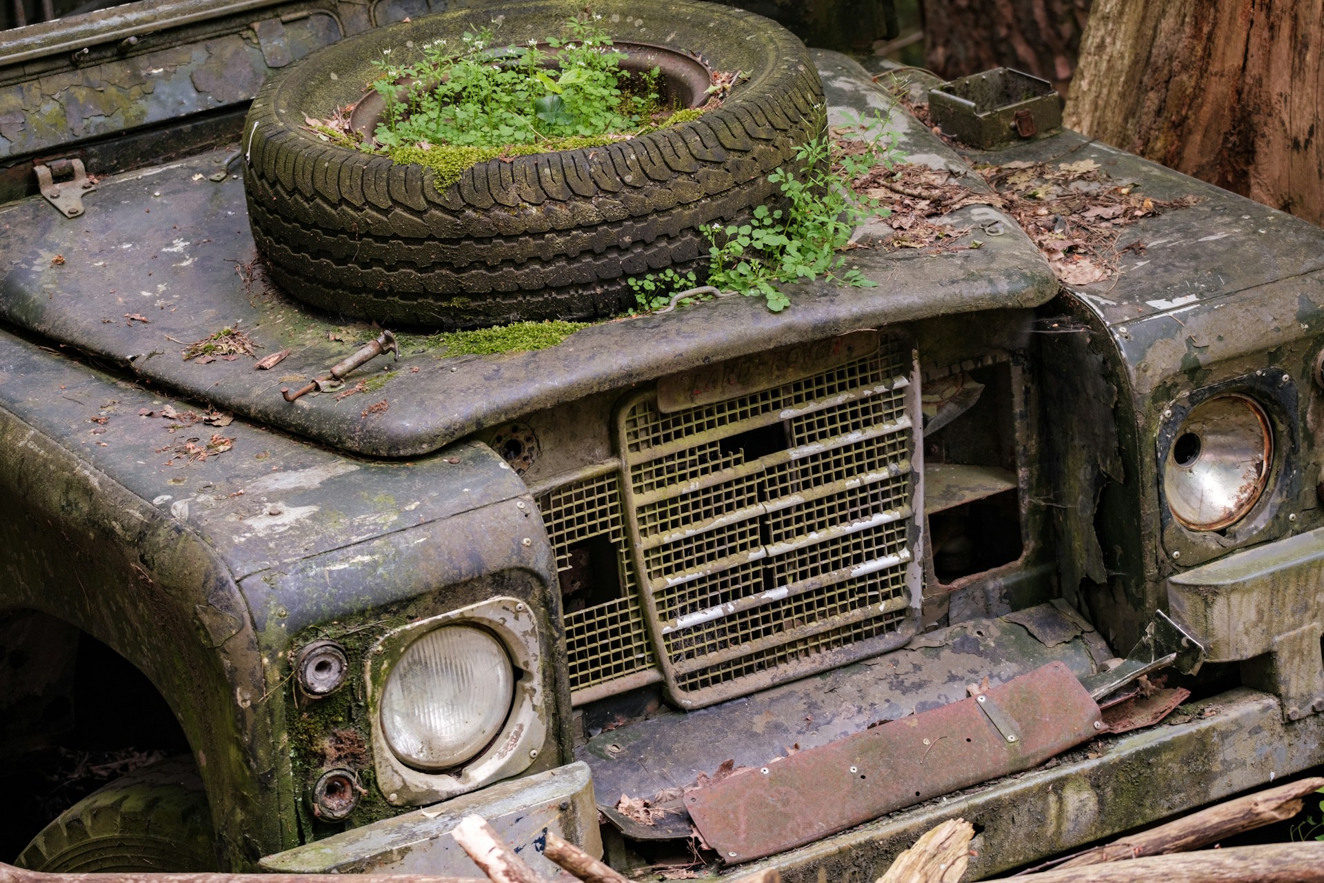 old rusty car with a tire on it