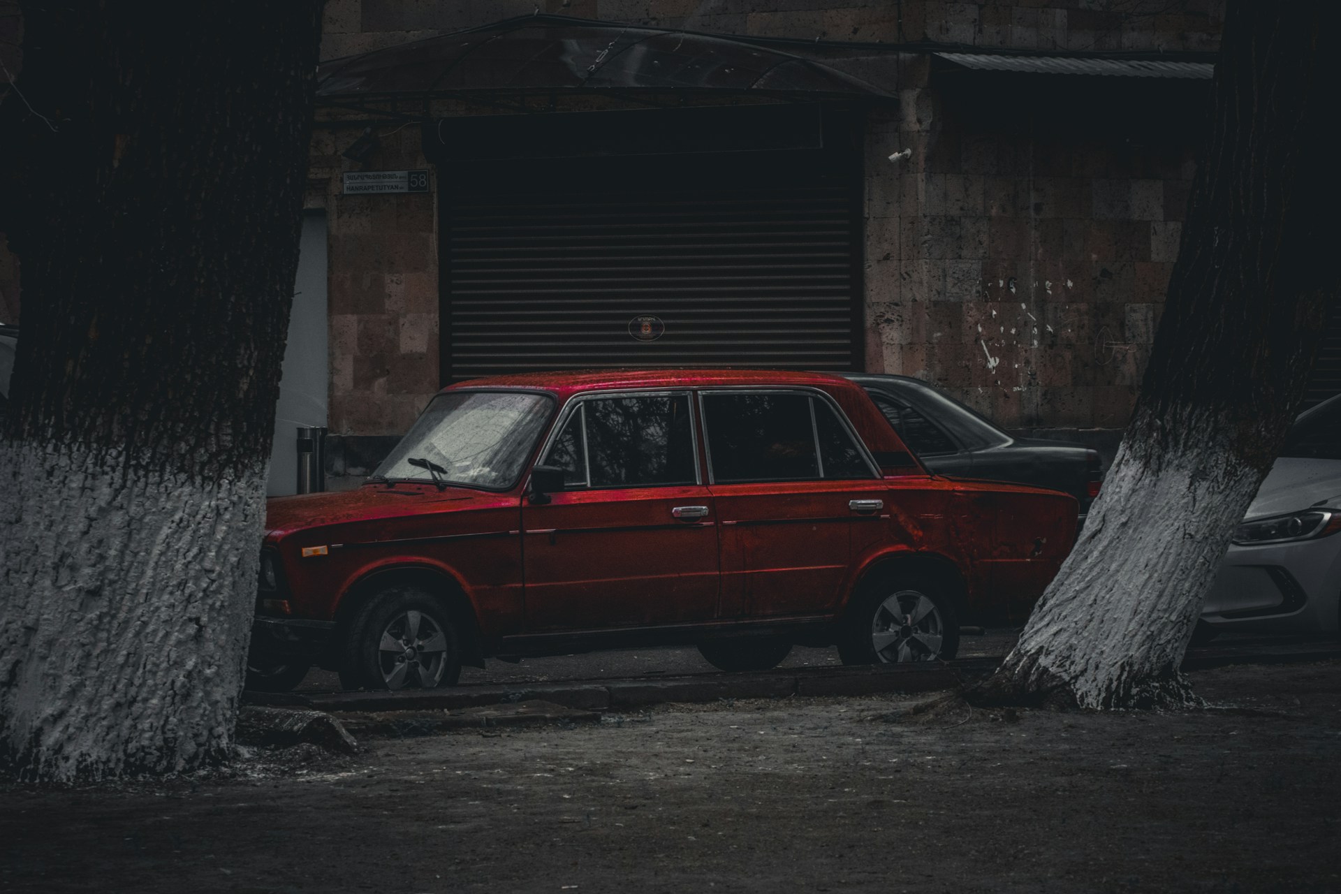 salvage sedan near a new car