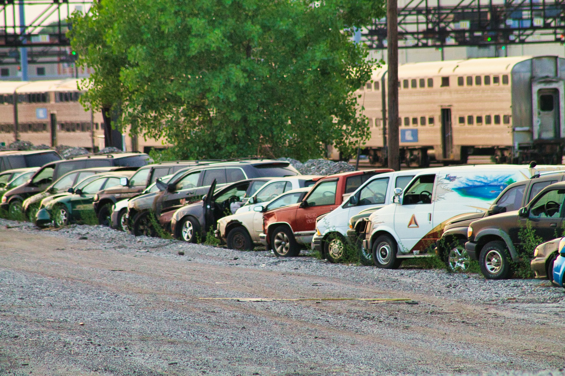 abandoned salvage cars near a train station