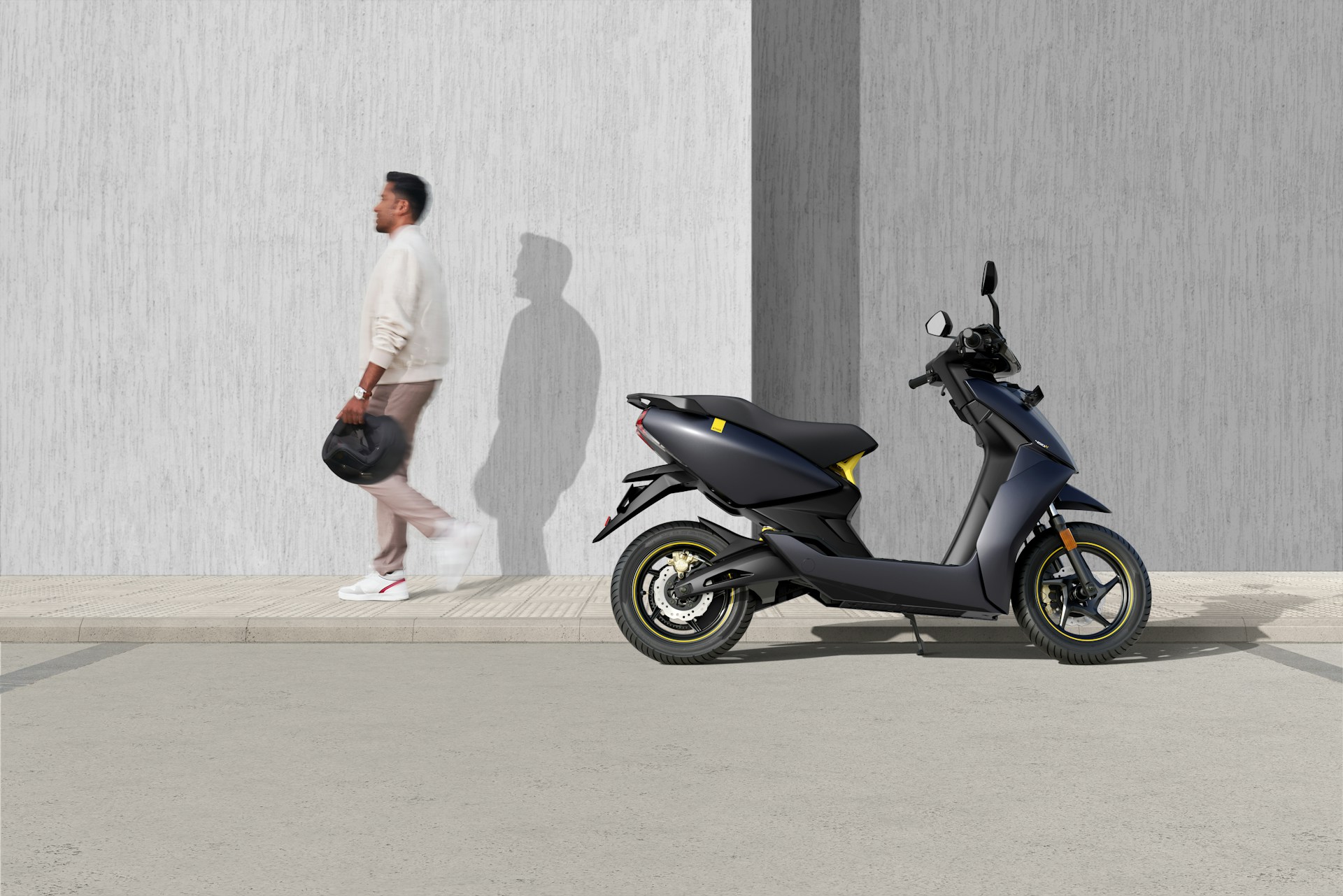 man on street near electric scooter