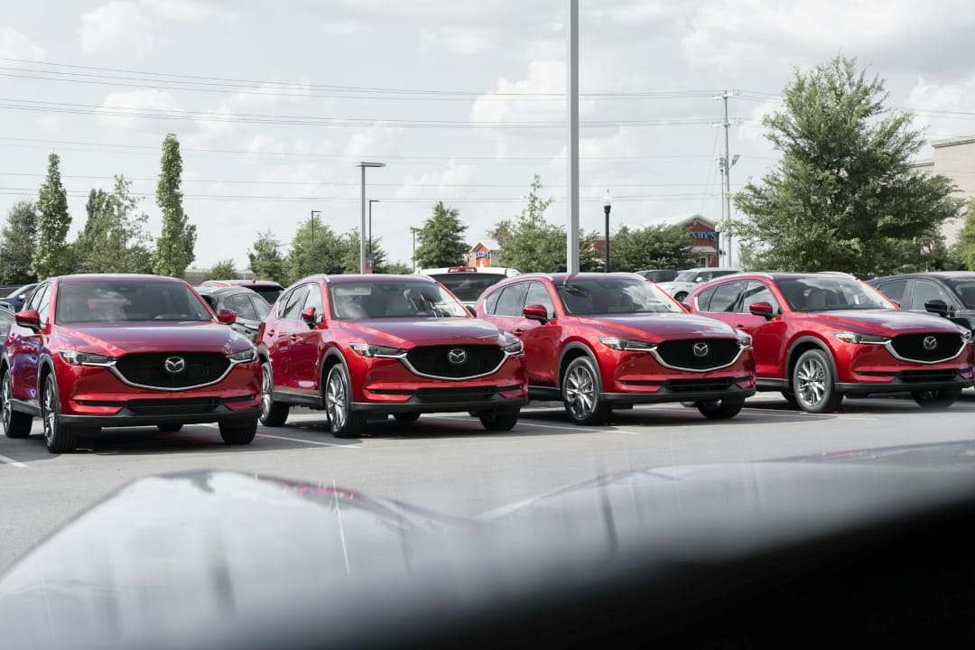 row of red Mazda SUVs parked on a dealership lot in Illinois