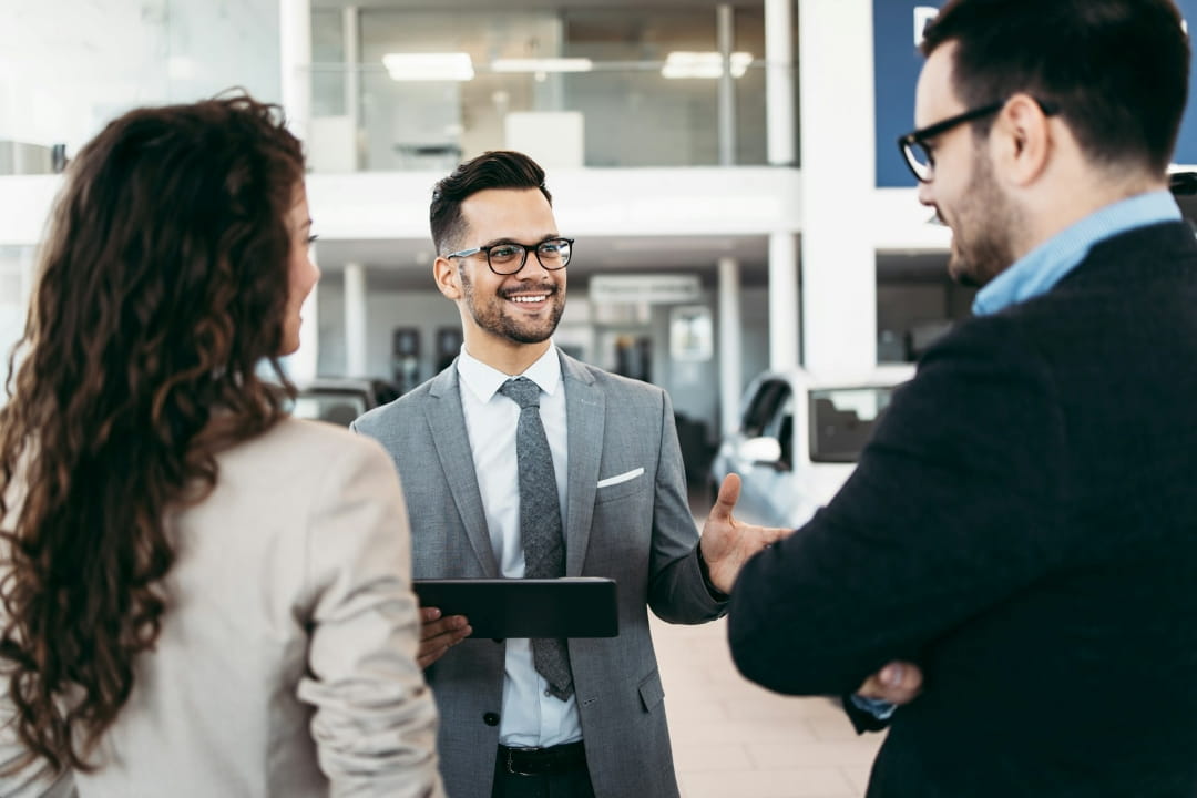 dealer representative talking with clients during a sales appointment