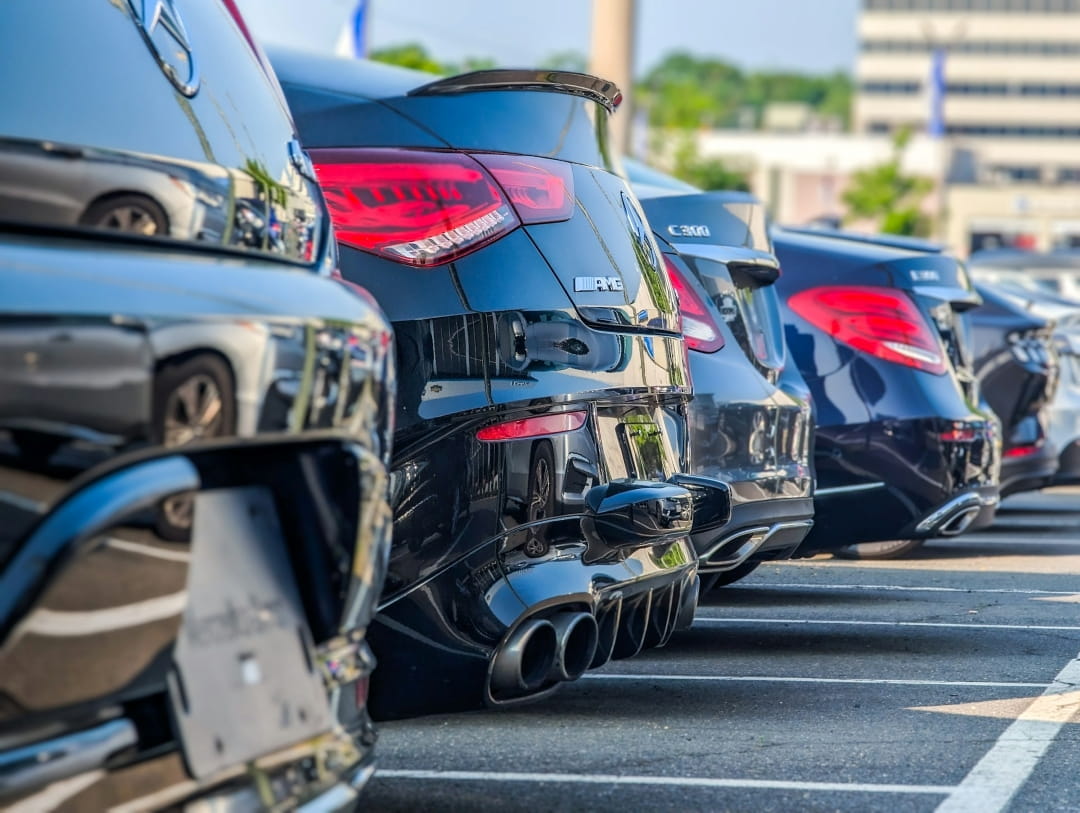 row of cars parked in a dealership lot ready for sale