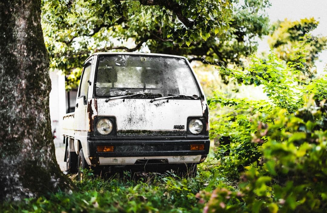 weathered pickup truck with visible rust and long-term outdoor exposure